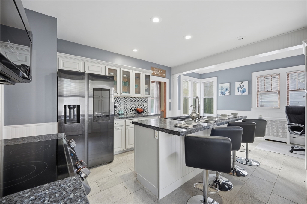 572 Springfield Street Chicopee, MA 01013 - Photo 20 of 42 a kitchen with stainless steel appliances granite countertop a refrigerator and a stove top oven