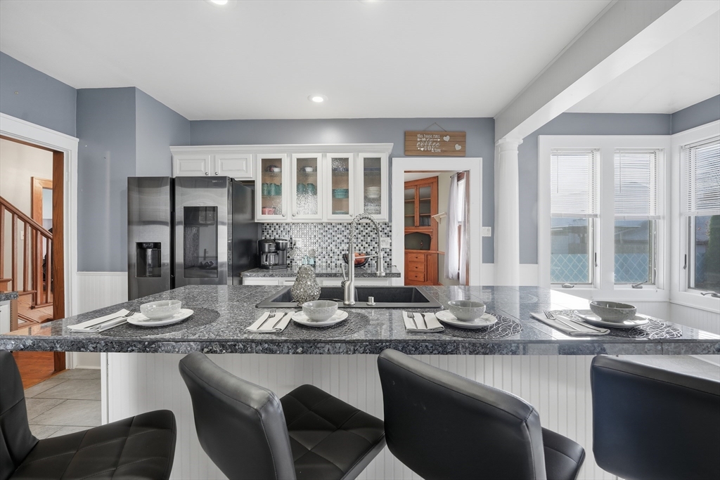 572 Springfield Street Chicopee, MA 01013 - Photo 21 of 42 a kitchen with granite countertop a sink and stove