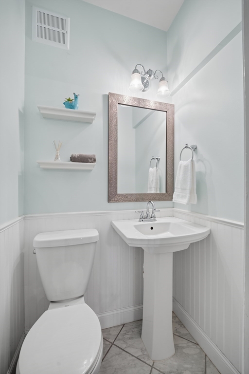 572 Springfield Street Chicopee, MA 01013 - Photo 22 of 42 a bathroom with a toilet sink and mirror