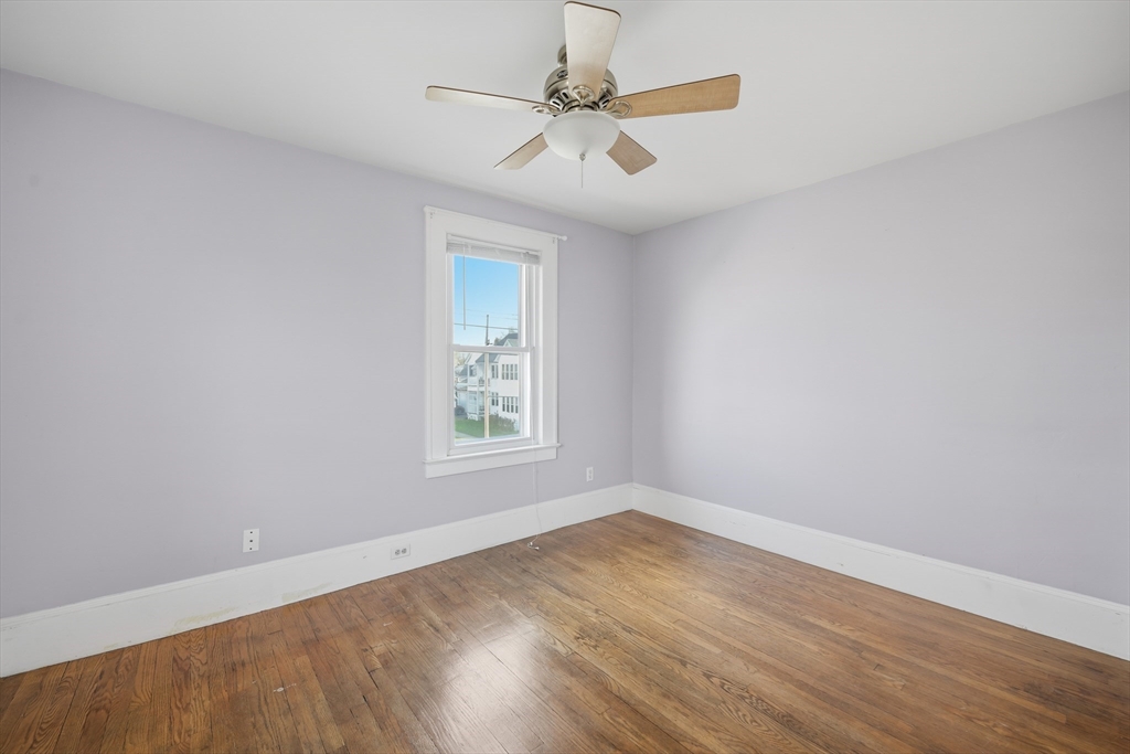 572 Springfield Street Chicopee, MA 01013 - Photo 24 of 42 an empty room with wooden floor and windows