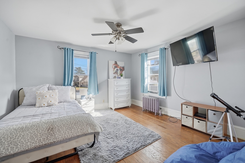 572 Springfield Street Chicopee, MA 01013 - Photo 29 of 42 a living room with furniture a flat screen tv and a rug