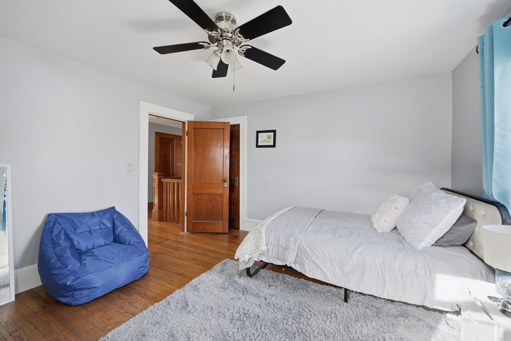 572 Springfield Street Chicopee, MA 01013 - Photo 30 of 42 a bedroom with a bed couch and window