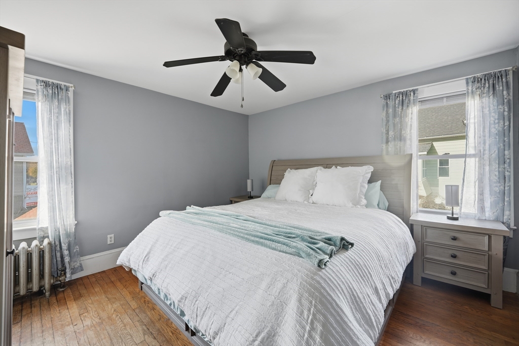 572 Springfield Street Chicopee, MA 01013 - Photo 32 of 42 a bedroom with a bed and wooden floor