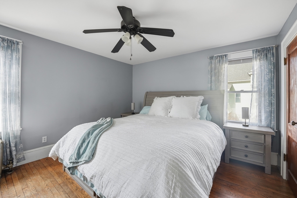 572 Springfield Street Chicopee, MA 01013 - Photo 35 of 42 a bedroom with a bed and wooden floor
