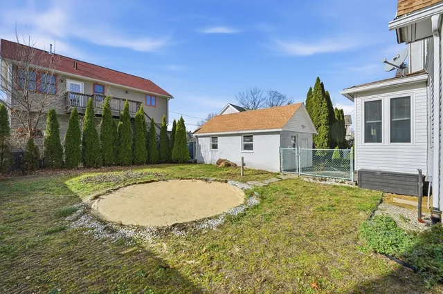 a view of a house with backyard and a tree
