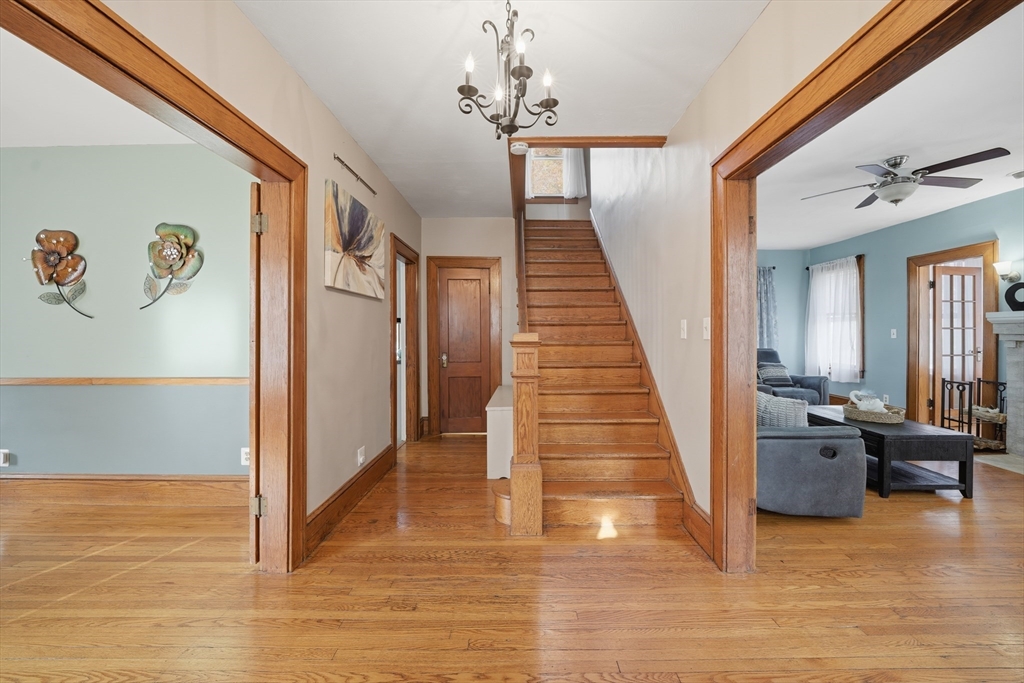 572 Springfield Street Chicopee, MA 01013 - Photo 5 of 42 a view of a hallway with wooden floor and staircase