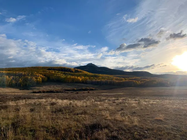 a view of a lake with sunset