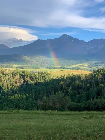 a view of an mountain and a yard