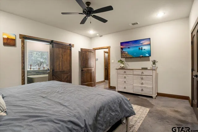 a bedroom with a bed and a flat screen tv