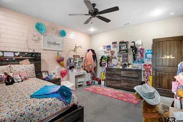 a bedroom with bed and a chandelier