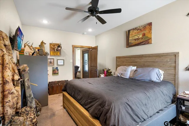 a bedroom with a large bed and a chandelier