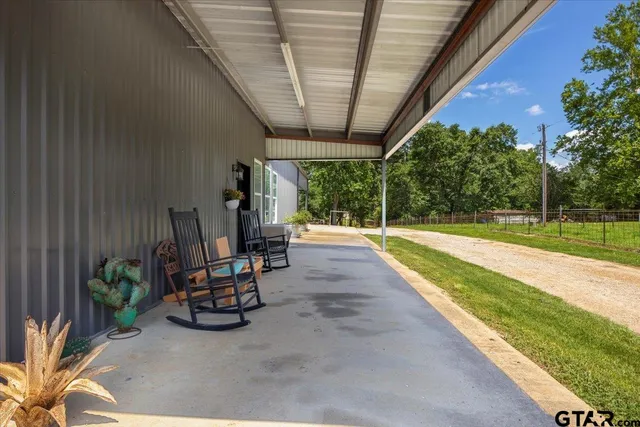 a view of a swimming pool with a patio and a garden