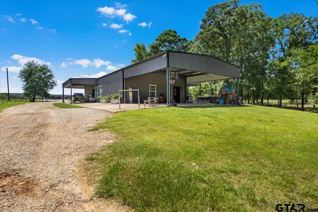 a view of a house with a yard and garage