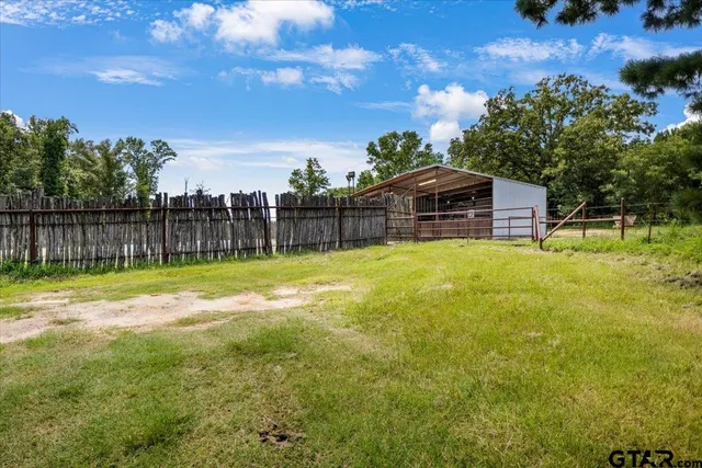 a view of a house with a yard and sitting area