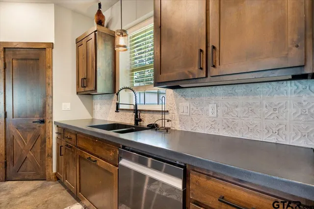 a kitchen with stainless steel appliances granite countertop a sink a microwave cabinets and a counter space