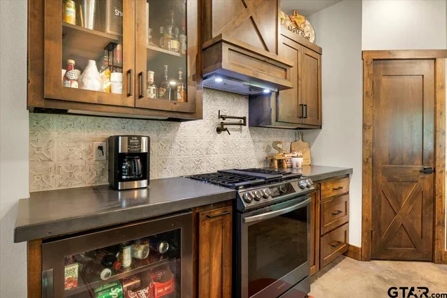 a kitchen with stainless steel appliances granite countertop a stove and a microwave