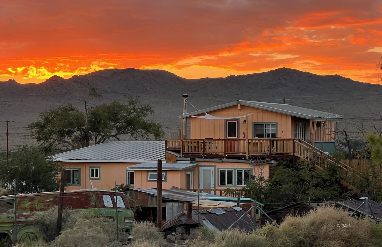 a aerial view of a house next to a big yard
