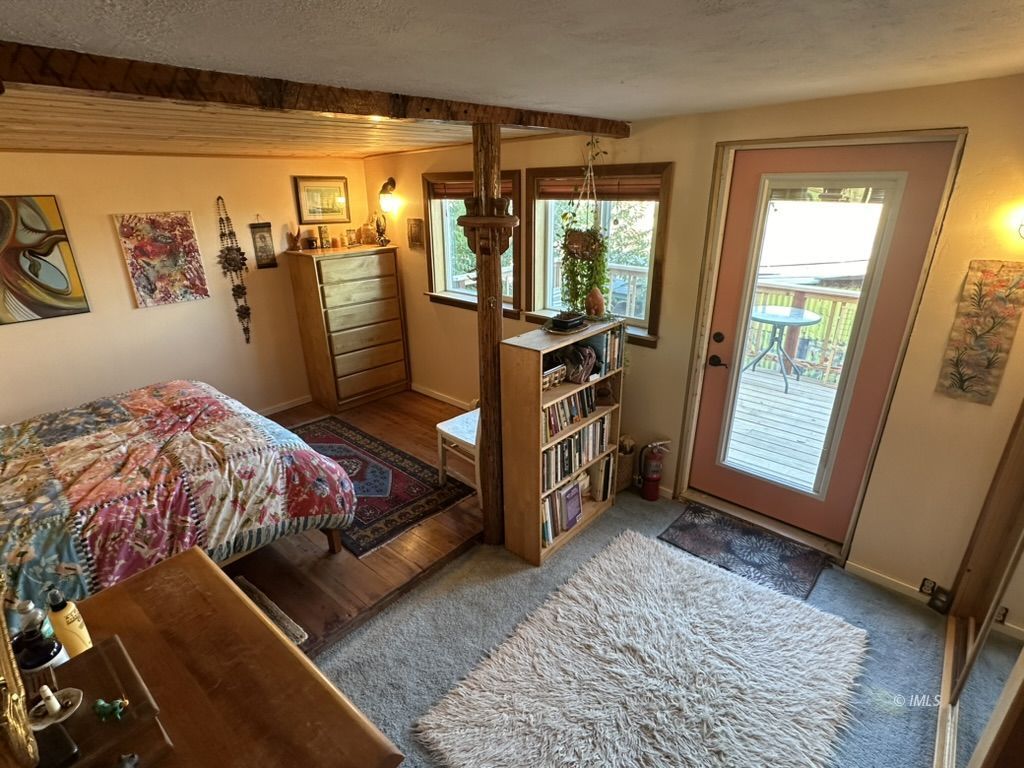 220 East Fulton Street Darwin, CA 93522 - Photo 13 of 34 a bed sitting in a bedroom next to a window