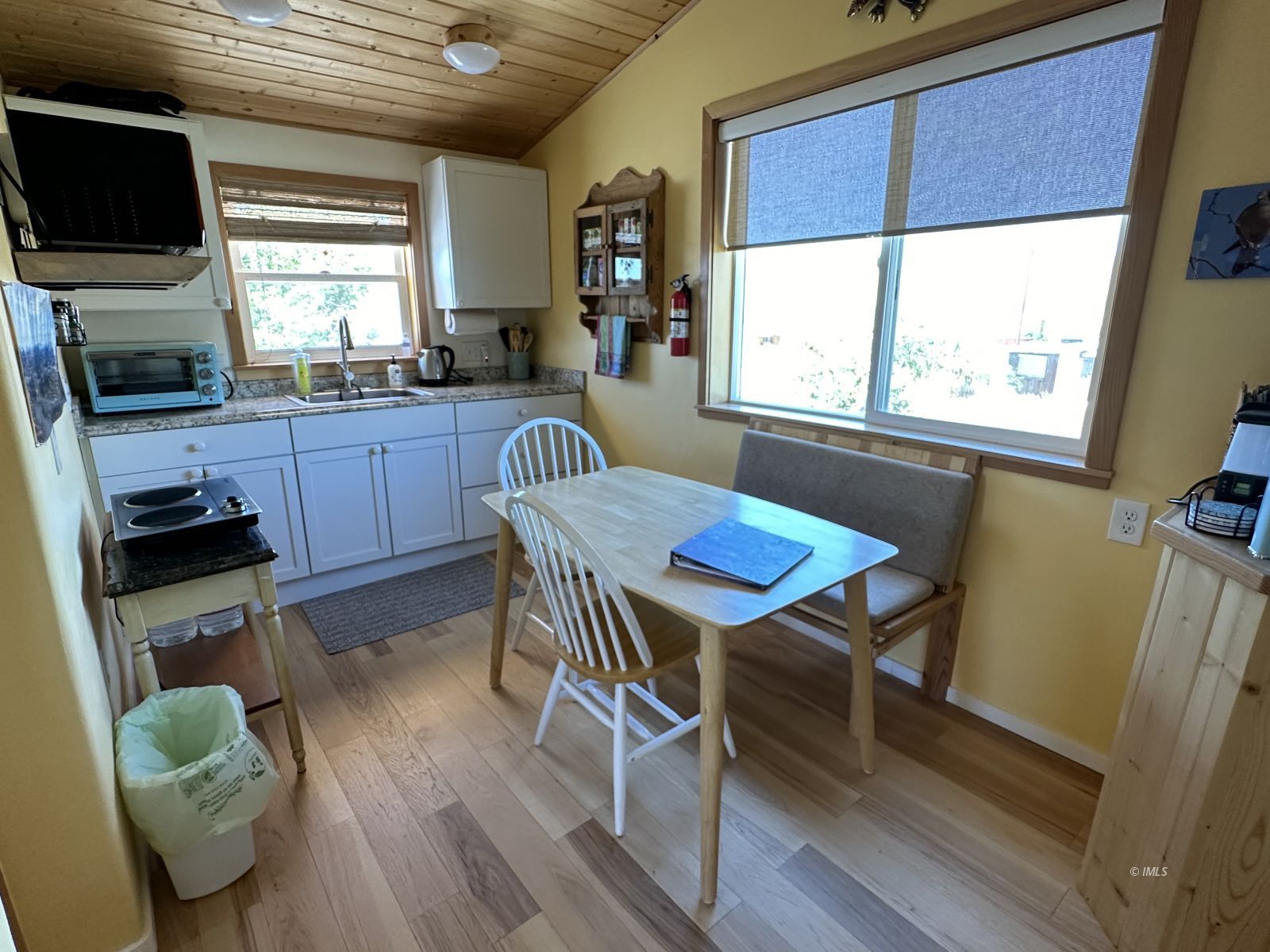 220 East Fulton Street Darwin, CA 93522 - Photo 17 of 34 a kitchen with a table chairs sink and microwave