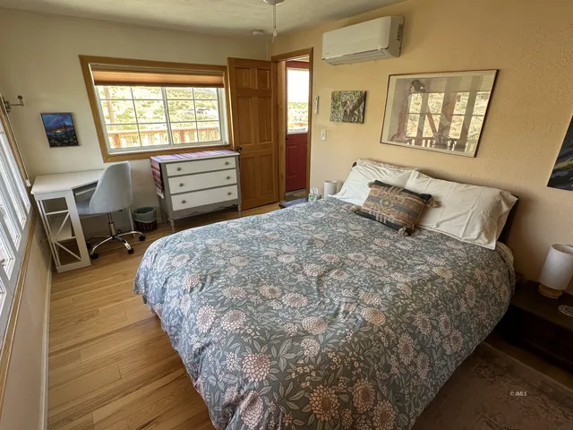 a bedroom with a bed and a chandelier