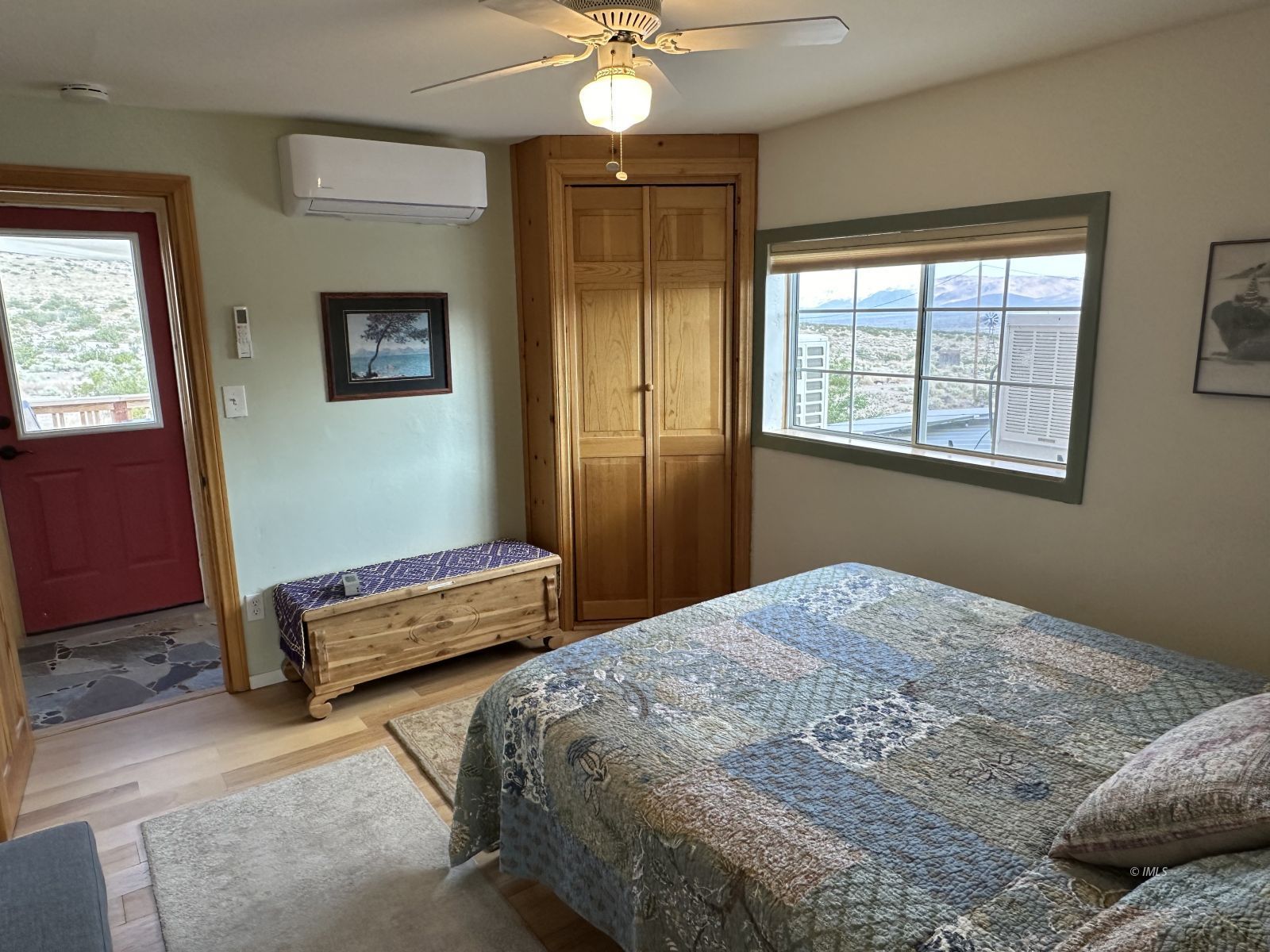 220 East Fulton Street Darwin, CA 93522 - Photo 19 of 34 a bedroom with a bed and a chandelier