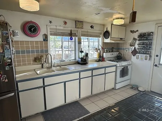 a kitchen with a sink cabinets and window