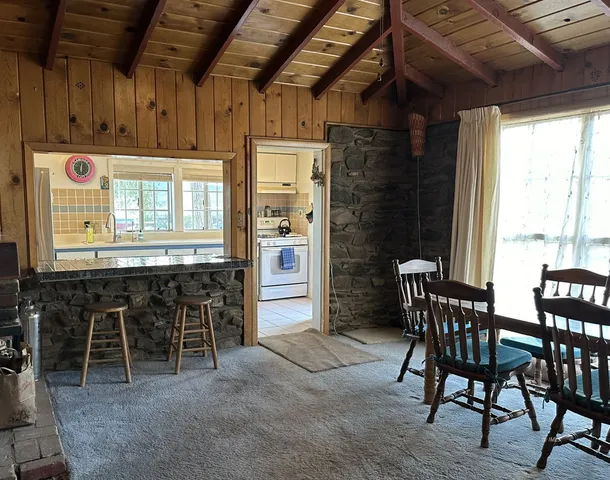 a dining room with furniture and window