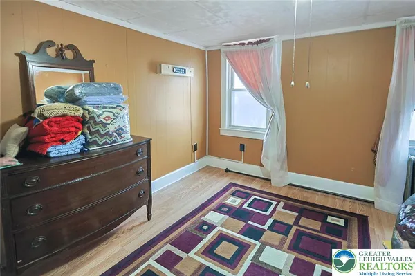 a bedroom with a bed and a window in it