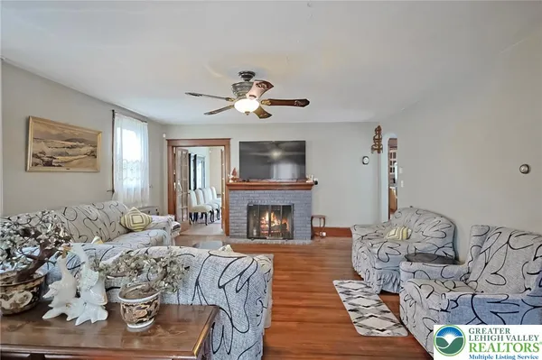 a living room with furniture fireplace and flat screen tv