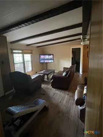 a living room with furniture rug and wooden floor