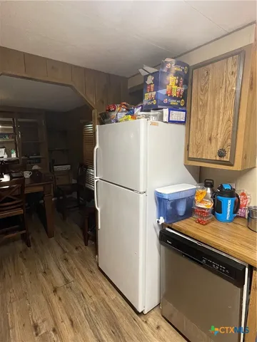 a kitchen with refrigerator and window
