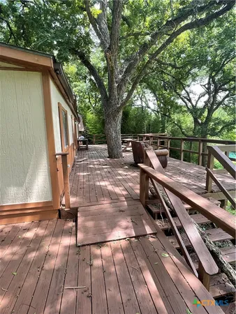 a view of outdoor space with wooden floor and seating