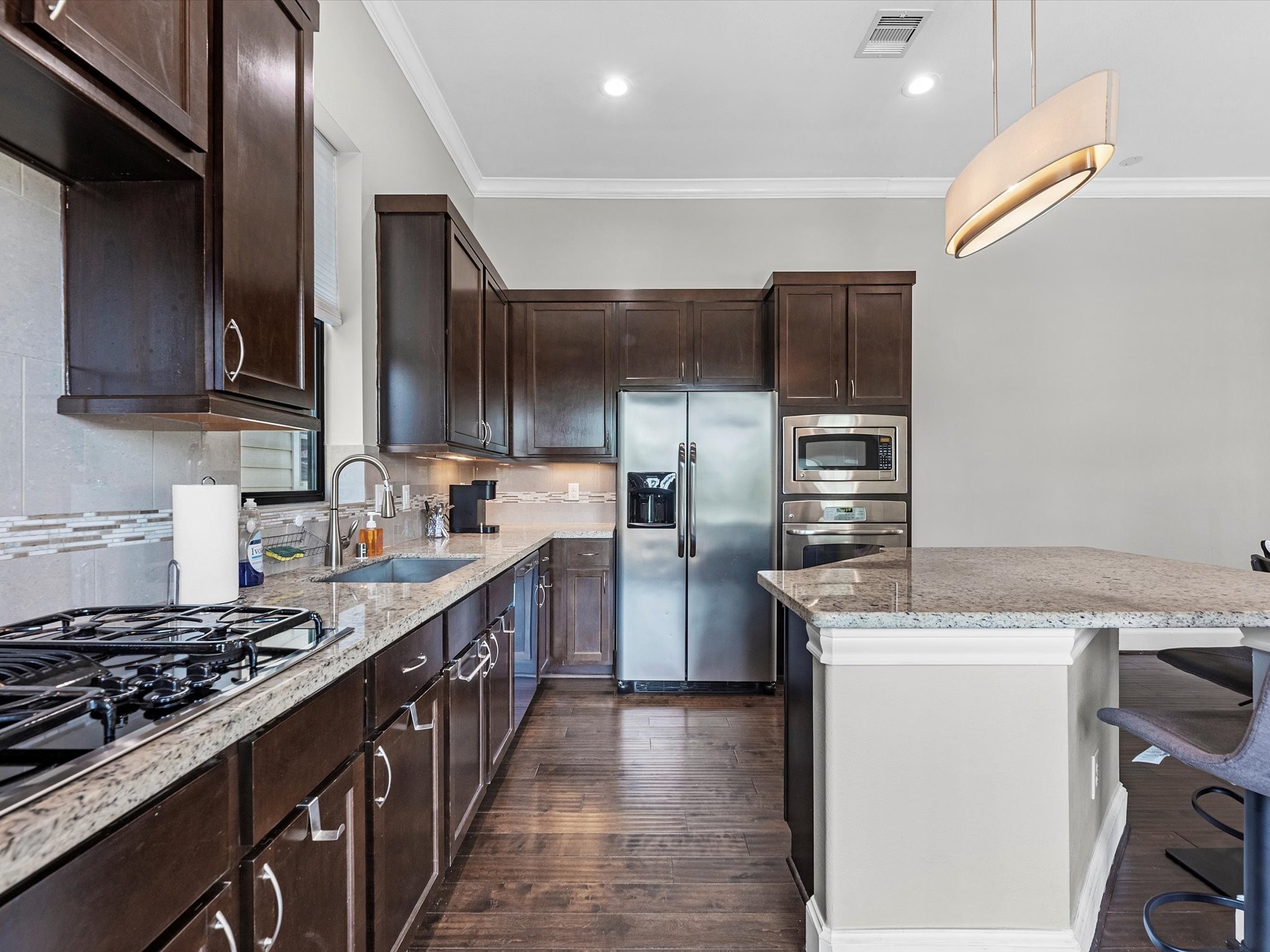 3610 Chenevert Street Houston, TX 77004 - Photo 13 of 32 Here's a sleek, modern kitchen with elegant cabinetry and high-end appliances.