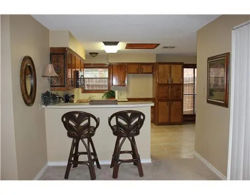 a kitchen with stainless steel appliances granite countertop a sink and a refrigerator