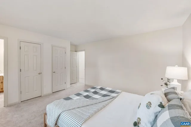 a bedroom with a bed and white wall