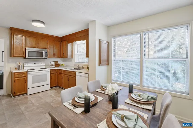 a kitchen with furniture a sink and white appliances