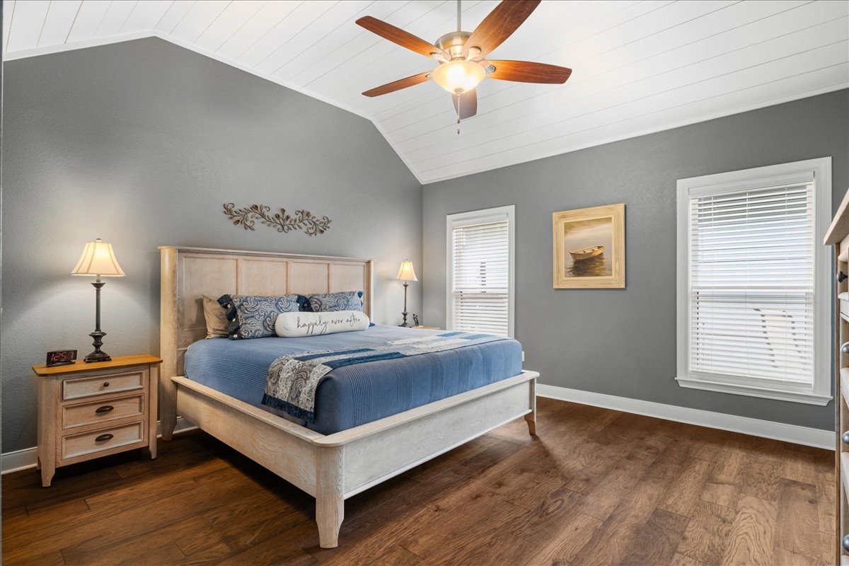 1207 Pecan Street Brenham, TX 77833 - Photo 13 of 29 a bedroom with a bed and a chandelier