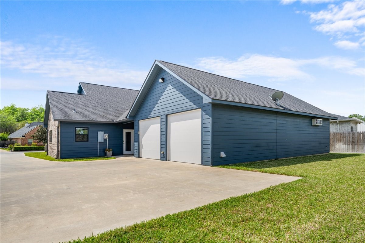 1207 Pecan Street Brenham, TX 77833 - Photo 5 of 29 a view of a house with a yard and garage