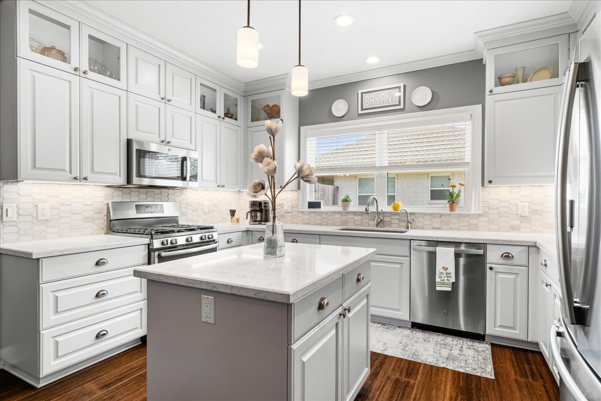 1207 Pecan Street Brenham, TX 77833 - Photo 6 of 29 a kitchen with stainless steel appliances a sink stove and cabinets