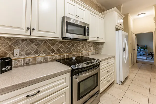 a kitchen with stainless steel appliances granite countertop a stove and a microwave