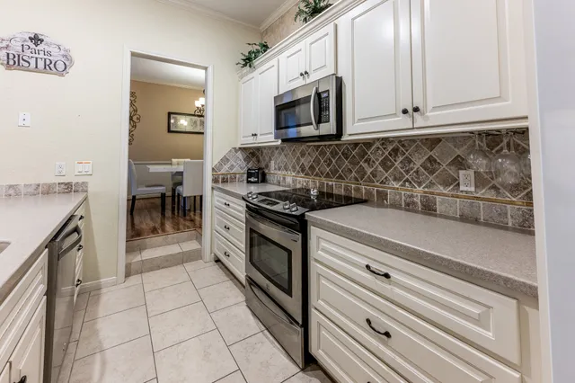 a kitchen with cabinets and window