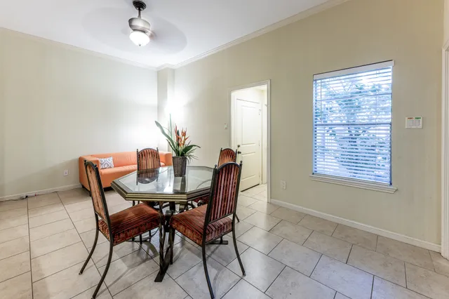 a dining room with furniture and kitchen view