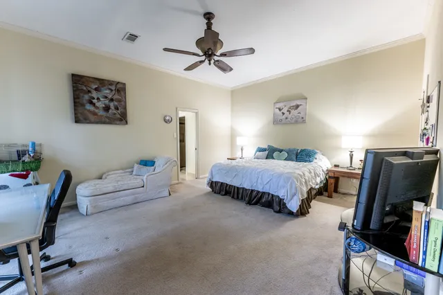 a bedroom with a bed and a tv