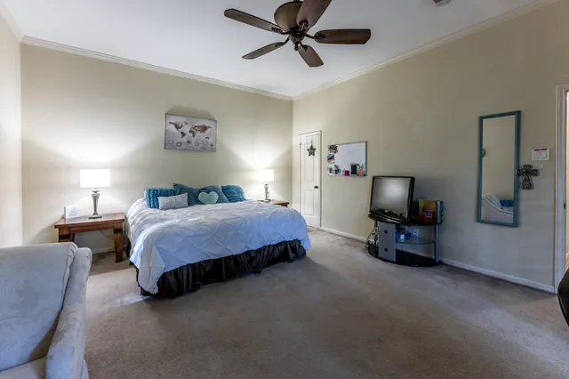 a bedroom with a bed and a chandelier