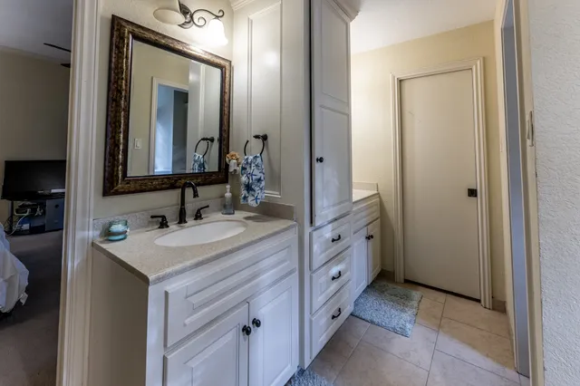 a bathroom with a sink vanity and mirror