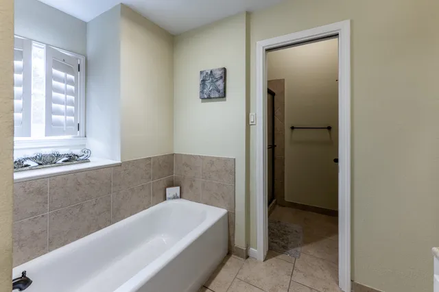 a bathroom with a shower and a mirror