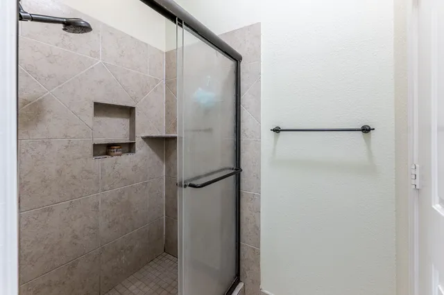 a bathroom with a tub sink and mirror