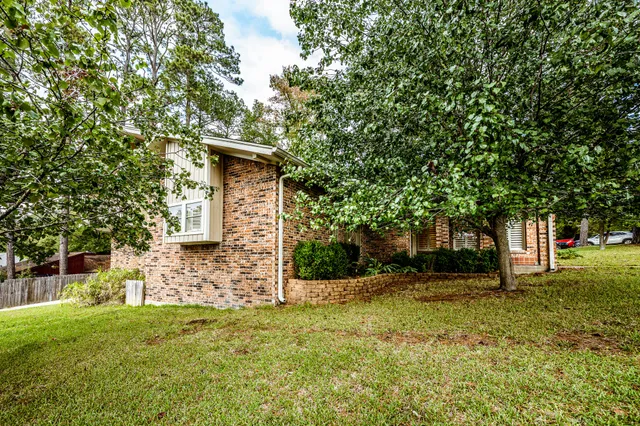 a view of a house with a backyard