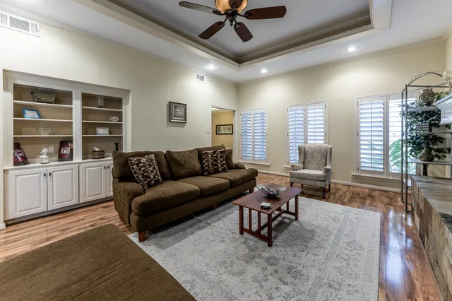 a living room with furniture a fireplace and a chandelier
