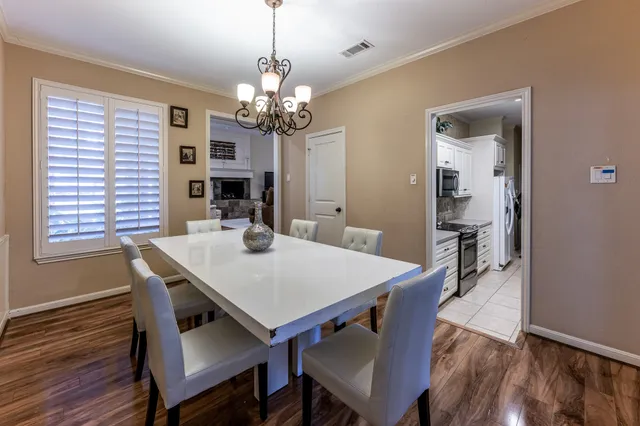 a view of a dining room with furniture wooden floor and a chandelier
